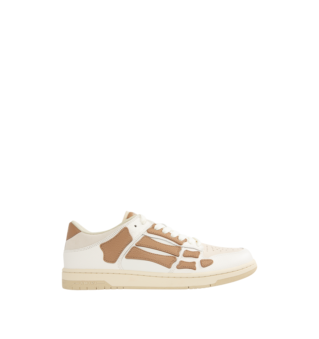 Image 1 of 5 - BROWN - AMIRI Skel Top Low Sneakers featuring low-top grained leather and cotton twill sneakers, perforations at toe, logo patch at padded tongue, padded collar, graphic appliqus at sides and logo printed at heel tab. Upper: leather, textile. Sole: rubber.