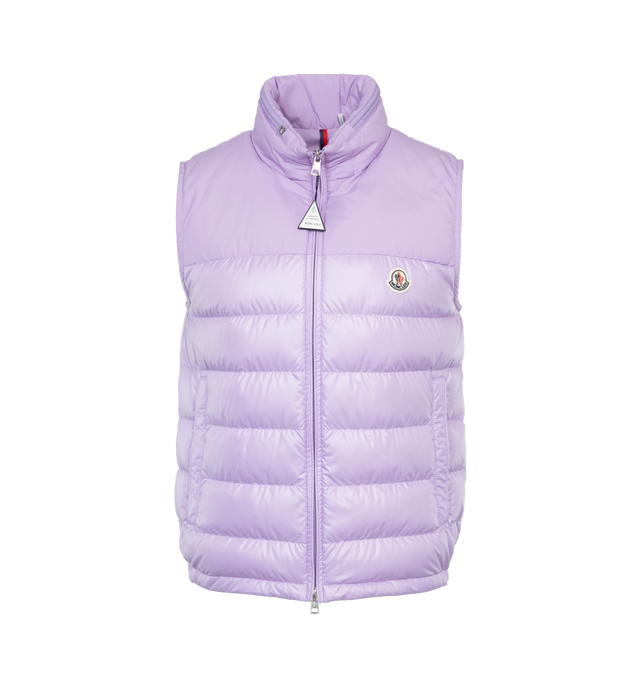 Image 1 of 5 - PURPLE - MONCLER Cerces Down Vest featuring stowaway hood at stand collar, two-way zip closure, felted logo patch at chest, zip pockets, elasticized hem, zip pocket at interior, fully lined and logo-engraved silver-tone hardware. 100% polyester. Fill: 90% duck down, 10% feathers. 