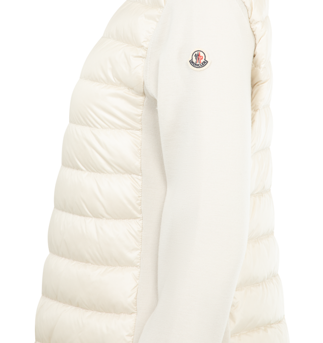 Image 3 of 3 - WHITE - MONCLER Padded Wool Zip-Up Cardigan featuring an attached drawstring hood, front zip closure, channel-quilted body, ribbed cuffs and hem, zip pockets, flap sleeve pocket, and logo patch detail. Lined body and hood. 100% polyamide/nylon. Padding: 90% down, 10% feather.