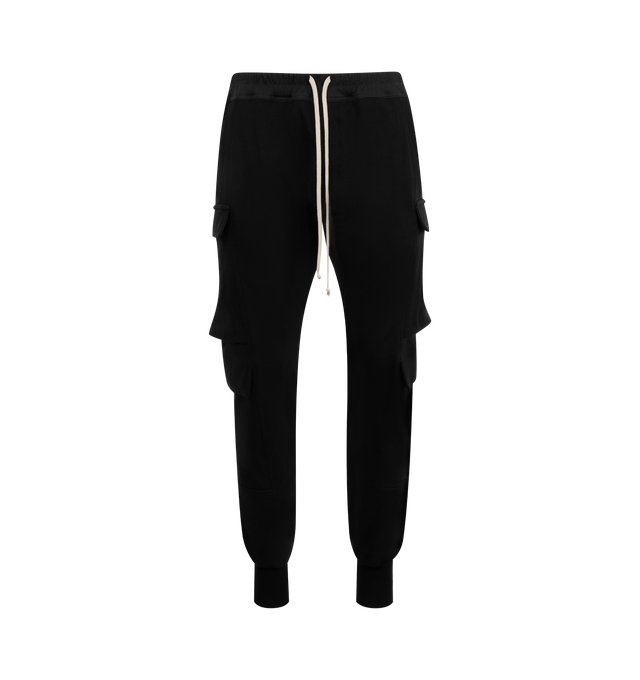 Image 1 of 3 - BLACK - RICK OWENS Men's Mastodon Megacargo Tapered Cotton-Jersey Drawstring Trousers in a comfortable heavyweight cotton-jersey. Pull-on style featuring signature elongated drawstrings, cargo pockets on each leg, ribbed trim at ankles. 100% cotton.