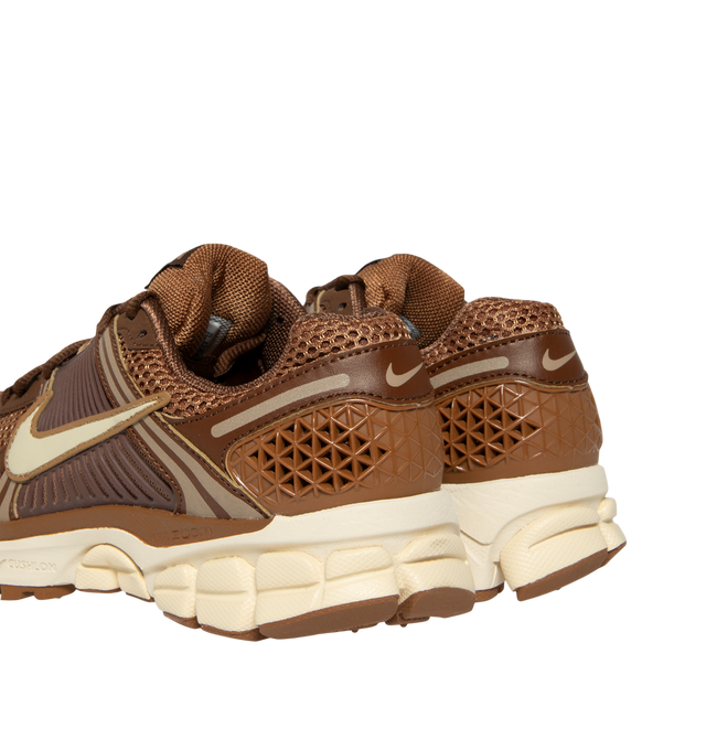 Image 3 of 5 - BROWN - Nike Womens Zoom Vomero 5 Sneakers feature a layered design with textile, synthetic leather, and plastic accents. Finished with Zoom Air cushioning, supportive side caging, reflective details, and a durable rubber outsole. Main Material: Textile, Synthetic Leather, Plastic; Outsole: Rubber. Imported