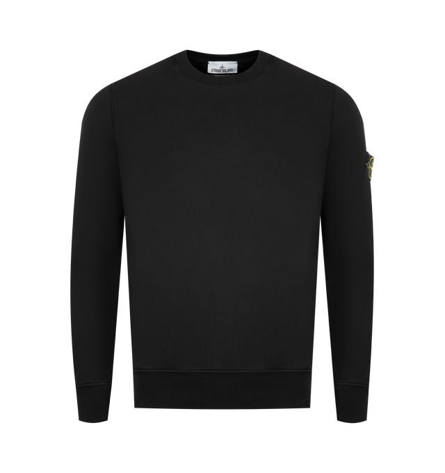 Image 1 of 3 - BLACK - STONE ISLAND Crewneck Sweatshirt featuring ribbed neckline, lunette under back neckline with internal reinforcement, raglan sleeves on back, Stone Island badge on left sleeve, ribbed cuffs and bottom band, overlock stitching at seams and regular fit. 100% cotton.