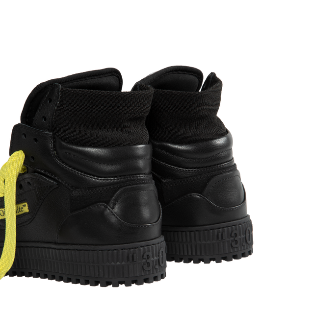 Image 3 of 5 - BLACK - OFF-WHITE 3.0 OFF COURT CALF LEATHER are high top "Off-Court" 3.0 sneakers in black with Off-White logo on one side. Yellow and black labels detailing. Black rubber sole. Yellow lace-up closure. Outer: 30% Cotton Outer: 55% Leather Outer: 10% Polyamide Outer: 4% Polyester Sole: 100% Rubber Outer: 1% Elastane. 