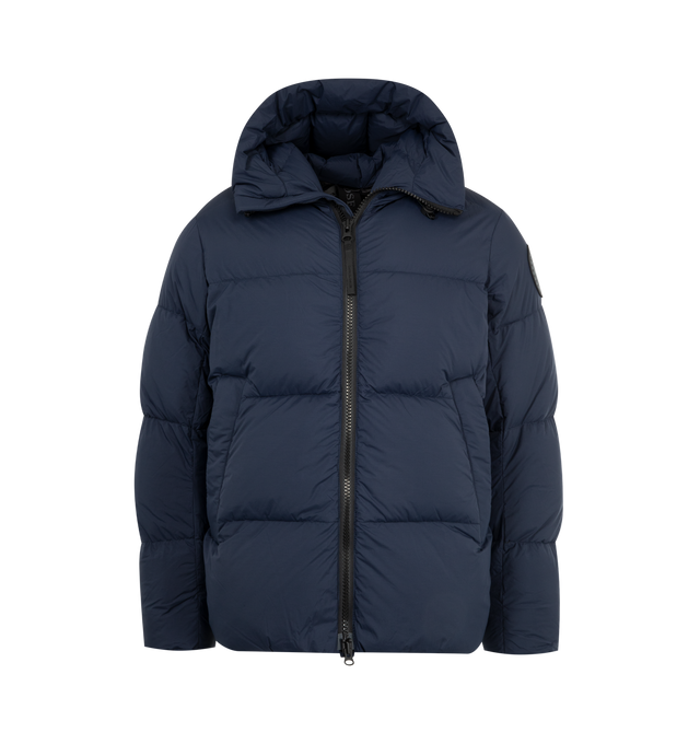 Image 1 of 3 - NAVY - CANADA GOOSE Crofton Puffer featuring an adjustable hood, a drawcord at the hem to customize the fit and lock in warmth, packable into interior left pocket, converts into a cinchable bag with a carrying strap, down-filled adjustable hood with drawcord, two-way zipper, recessed rib-knit cuffs, two fleece-lined zippered hand pockets and two interior mesh drop-in pockets. 100% recycled polyamide. Made in Canada.