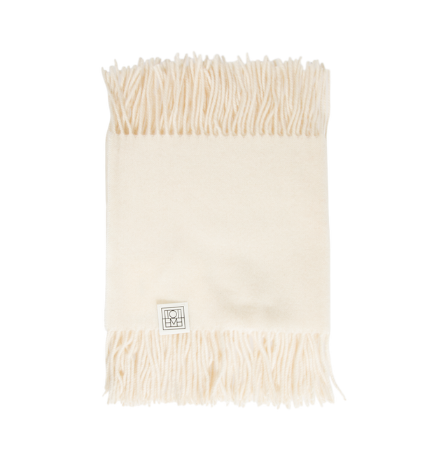 Image 1 of 2 - CREAM - Toteme Women's Fringed Cashmere Blend Scarf is crafted from a luxurious cashmere blend and features a timeless oversized silhouette designed for versatile cold-weather layering. Main Material: 90% Recycled GRS Cashmere, 5% Cashmere, 3% Wool.