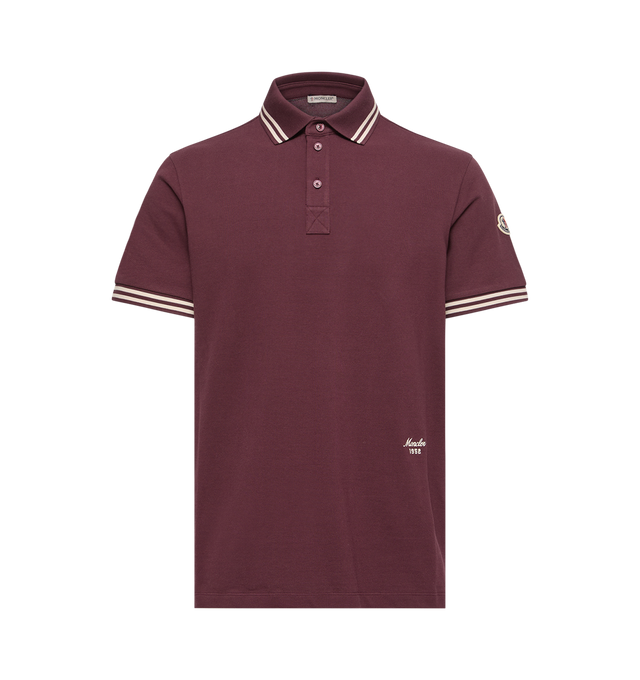 Image 1 of 1 - RED - Moncler Mens Striped Trim Cotton Piquet Polo Shirt is crafted from cotton piquet and features a classic collar, striped rib-knit trim, short sleeves, a button-front placket, and an embroidered logo. This designer cotton polo shirt combines varsity-inspired detailing with a timeless short-sleeve silhouette for elevated everyday wear. Main Material: 100% Cotton; Collar & Cuffs: 99% Cotton, 1% Elastane. Made in Turkey.
