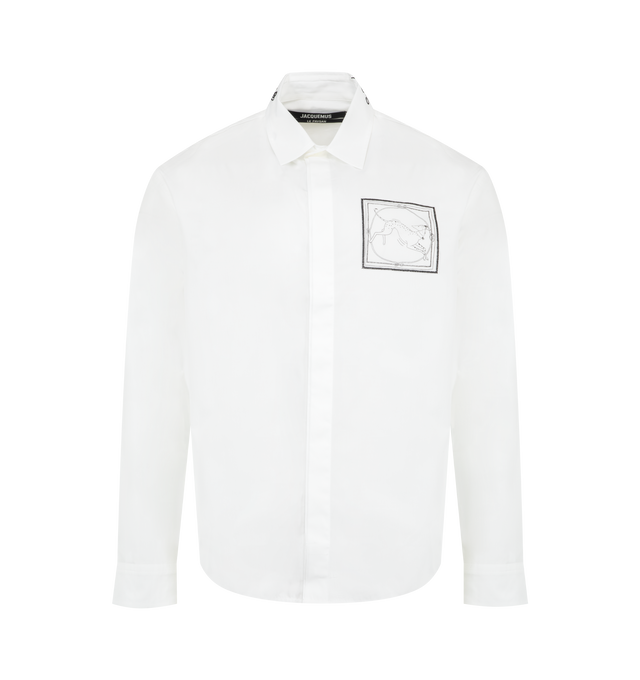 Image 1 of 2 - WHITE - JACQUEMUS Simon Long-Sleeve Shirt featuring straight fit, cotton poplin, embroidered patch with Dog print, pointed collar, embroidered logo on the collar, hidden button placket, square cuffs with hidden buttons, embroidered 50s logo on the front, J" loop on the the back, back yoke, rounded pleat in the back and mother-of-pearl buttons. 100% cotton. Made in France.