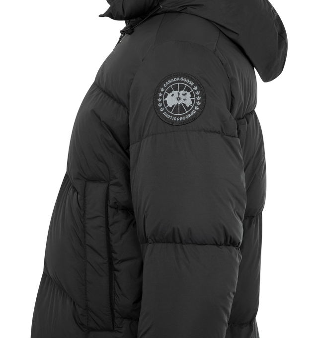 Image 3 of 3 - BLACK - CANADA GOOSE Crofton Puffer featuring an adjustable hood, a drawcord at the hem to customize the fit and lock in warmth, packable into interior left pocket, converts into a cinchable bag with a carrying strap, down-filled adjustable hood with drawcord, two-way zipper, recessed rib-knit cuffs, two fleece-lined zippered hand pockets and two interior mesh drop-in pockets. 100% recycled polyamide. Made in Canada.
