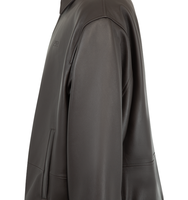 Image 4 of 4 - BROWN - Loewe Men's Drawstring Leather Jacket is crafted from lightweight nappa lambskin and features an adjustable drawstring hem. Designed with a relaxed fit and regular length, it is finished with a classic collar, concealed snap-button and zip-front fastening, snap-button cuffs, buttoned welt pockets, inside welt pockets, and a debossed Double L detail at the chest. Main Material: Nappa lambskin. Fully lined. Made in Spain.