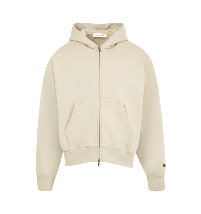 Image 1 of 2 - NEUTRAL - FEAR OF GOD ESSENTIALS Classic Fleece Zip-Up Hoodie made from 380gsm core fleece featuring a classic fit with signature Fear of God relaxed proportions. A new beveled metallic "Essentials Fear of God" logo is branded across the back. Details include a double-layer hoodie, rib-knit cuffs, waist-hem, and a kangaroo pocket. A "Fear of God Essentials" rubberized label is stitched on the hood and sleeve. 80% cotton, 20% polyester fleece.