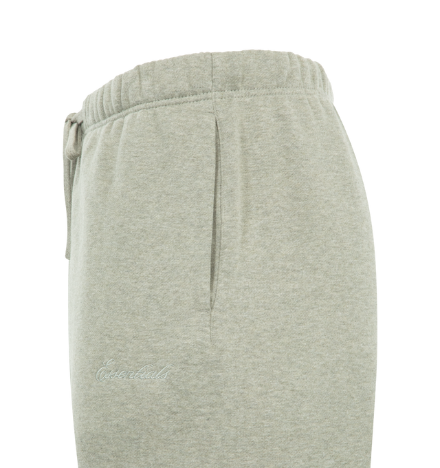 Image 3 of 3 - GREY - FEAR OF GOD ESSENTIALS Signature Classic Sweatpant featuring 380GSM core fleece, relaxed silhouette, elastic hem, encased elastic waistband with elongated drawcords, side seam pockets, embroidered Essentials signature logo on the leg and an Essentials signature label at the center front. 80% cotton, 20% polyester.