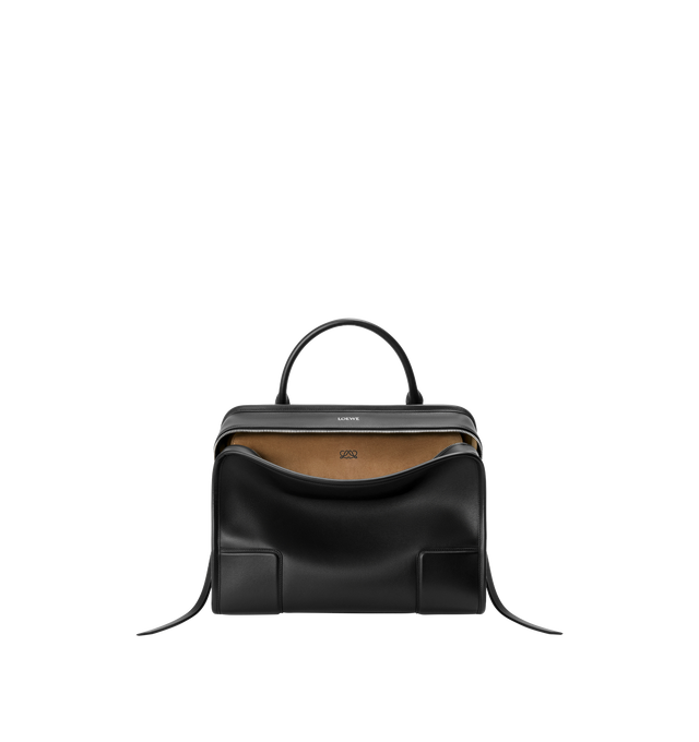 Image 1 of 16 - BLACK - Loewe Amazona 180 large bag takes on a relaxed silhouette anchored by a single toron top handle. It is designed to be carried open, while a concealed closure secures the main compartment. Removable shoulder and crossbody straps make it highly versatile. This large version is crafted in soft calfskin. Three carry options: short handle, removable shoulder strap and crossbody. Features zip closure with two leather zip pullers, two compartments, main compartment closed with magnetic clos