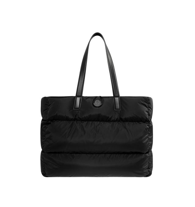 Image 1 of 3 - BLACK - MONCLER Caradoc Water-Repellent Tote Bag featuring nylon technique lining, calf leather trim, down-filled, leather handles, adjustable and detachable shoulder strap, snap button closure and inner zipped pocket. W 45 cm x H 35 cm x D 20 cm. 100% polyamide/nylon. Padding: 90% down, 10% feather. Made in Italy.