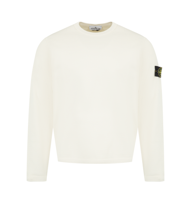 Image 1 of 3 - WHITE - featuring elasticated ribbed trim at neckline, cuffs, and hem, elasticated ribbed insert under armholes, Stone Island badge on left sleeve and regular fit. 100% cotton.