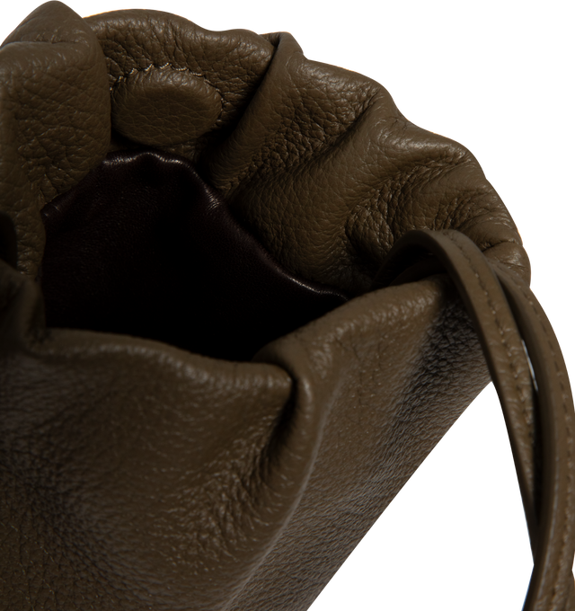 Image 3 of 3 - GREEN - THE ROW Bourse Phone Case featuring smooth nappa leather exterior with nappa leather lining and shoulder straps, magnetic closure, one main compartment, front embossed logo and knotted shoulder straps. 5.5" W x 8" H x 0.8" D. Shoulder strap with a 25" drop. Made in Italy.