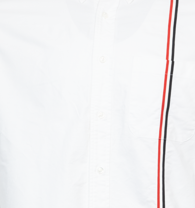 Image 3 of 3 - WHITE - THOM BROWNE RWB Stripe Shirt featuring spread collar, button closure, tricolor grosgrain trim at front and back, patch pocket, logo patch at front, shirttail hem, pleats at single-button barrel cuffs, tricolor gosgrain flag at back collar and locker loop at back yoke. 100% cotton. Made in Italy.