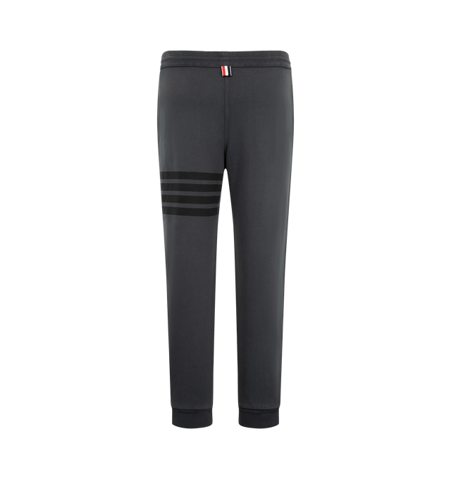 Image 2 of 3 - GREY - Thom Browne Men's Classic Loopback Sweatpants feature a pull-on waist with drawcords, and slim leg with signature stripes, logo patch and cuffed hems. Material: Cotton.