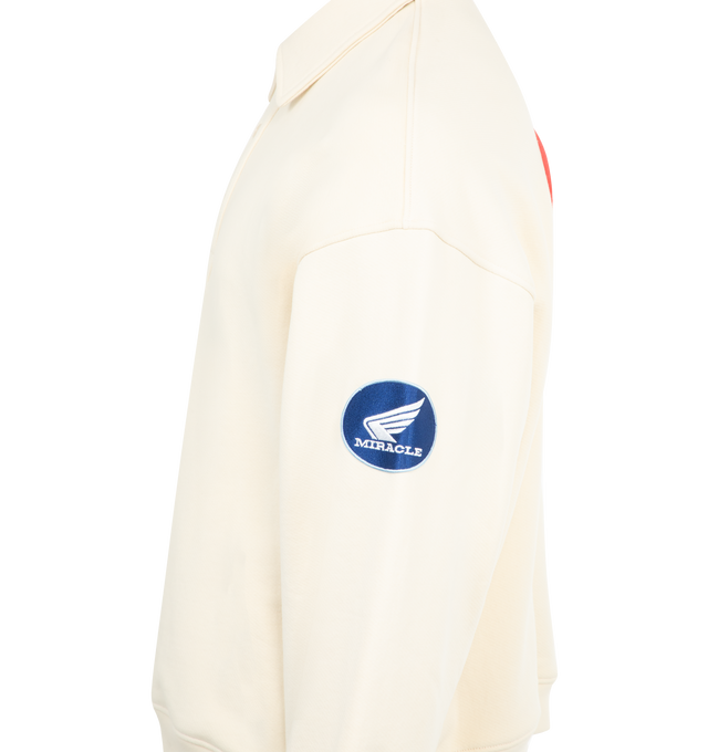 Image 3 of 4 - WHITE - NAHMIAS Polo Henley Shirt featuring long sleeves, half button collar, novelty patches at front chest and sleeves, logo embroidery on sleeve and ribbed cuffs and hem. 100% cotton.
