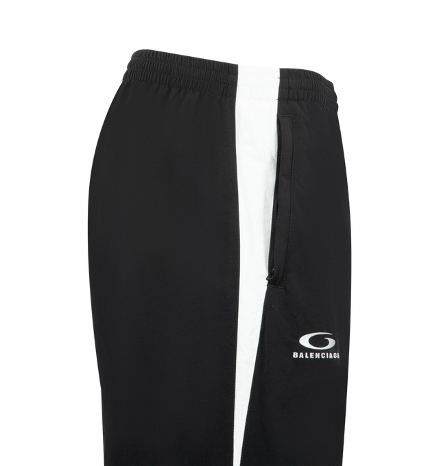 Image 3 of 4 - BLACK - BALENCIAGA NBA Tracksuit Pants featuring technical polyamide, contrasting yokes, mid-waist, elasticated waistband, 2 zipped slash pockets, loop sports icon artwork embroidered on right leg and NBA artwork embroidered on left leg. 100% polyamide. Lining: 100% polyester. Made in Portugal.