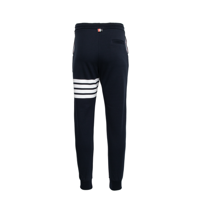 Image 2 of 5 - BLUE - THOM BROWNE cotton jersey sweatpants with pull-on waist featuring drawcords, side pockets and slim leg with signature stripes, logo patch and cuffed hems.  