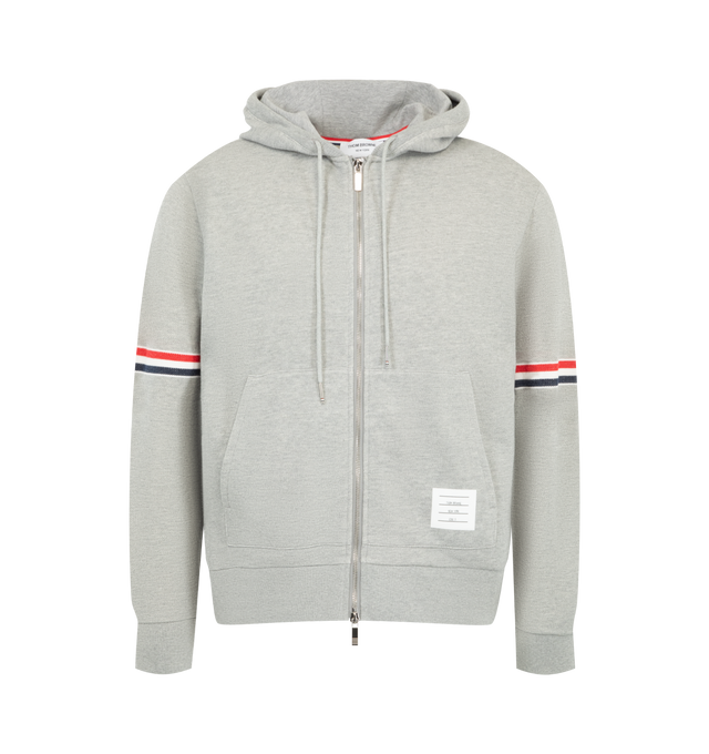 Image 1 of 2 - GREY - Thom Browne Men's Piqu Loopback Zip-Through Hoodie is crafted from cotton and features signature red, white, and blue striped grosgrain armbands. A drawstring hood, two-way front zip closure, side slip pockets, buttoned cuffs with striped grosgrain trim, and a signature grosgrain loop tab complete the design. Main Material: 100% Cotton. Made in Italy.