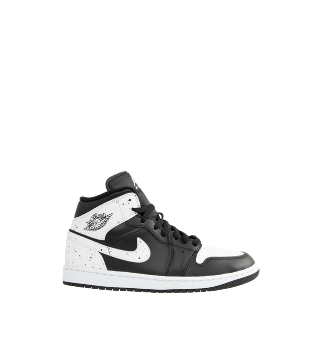 Image 1 of 5 - MULTI - Jordan Men's Air Jordan 1 Mid SE Sneakers feature a black and white upper crafted from genuine leather and textile. The mid-top silhouette is accented with a Wings logo at the collar and a Jumpman logo on the tongue, while an encapsulated Nike Air-Sole unit provides lightweight cushioning. Upper: Genuine Leather and Textile. Sole: Rubber.