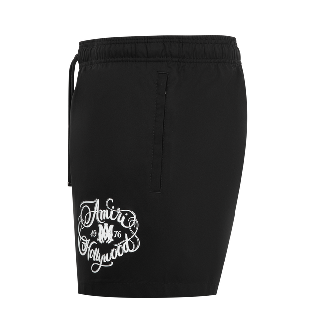 Image 3 of 3 - BLACK - AMIRI Hollywood Swim Shorts featuring polyester taffeta swim shorts, drawstring at elasticized waistband, three-pocket styling, logo graphic bonded at front, rubberized logo patch at back waistband and partial mesh lining. 100% polyester.
