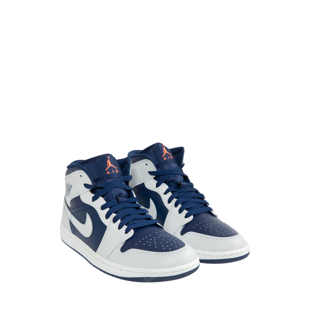 Image 2 of 5 - NAVY - JORDAN Air Jordan 1 Mid Sneaker featuring mid-top, leather, synthetic leather, textile upper, foam midsole, Nike Air cushioning and rubber outsole with pivot circle.
