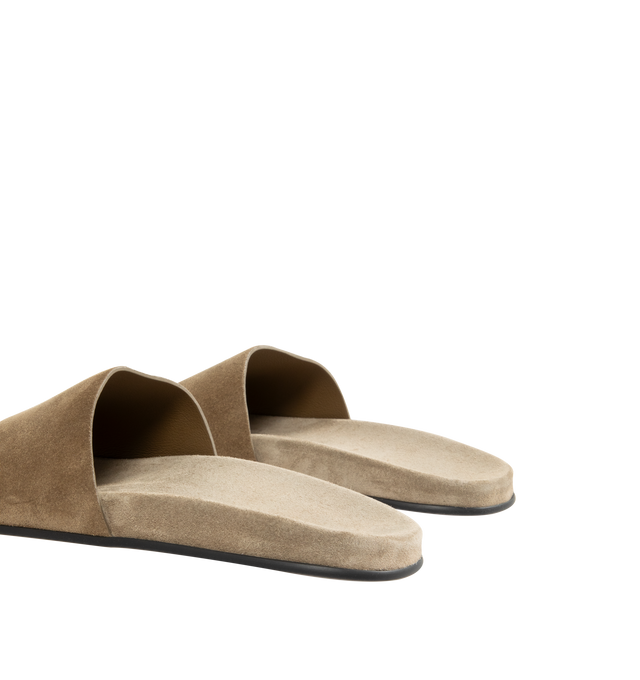 Image 3 of 4 - BROWN - THE ROW Hugh Slide featuring flat slip-on sandal in soft calfskin suede with contoured footbed and rubber sole. 100% calfskin leather. Synthetic sole. Made in Italy.