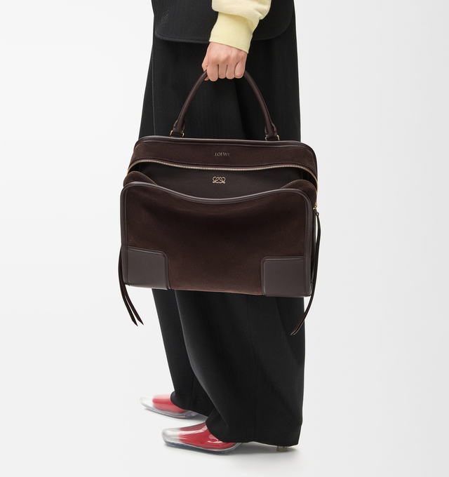 Image 2 of 16 - BROWN - LOEWE Large Amazona 180 Bag in suede featuring a relaxed silhouette anchored by a single toron top handle, designed to be carried open while a concealed closure secures the main compartment, removable shoulder and crossbody straps, zip closure with two leather zip pullers, two compartments, main compartment closed with magnetic closure, internal flat pocket, left side d-ring for customization, suede and nappa lambskin lining, embossed LOEWE and embossed double L branding. Suede/calf.