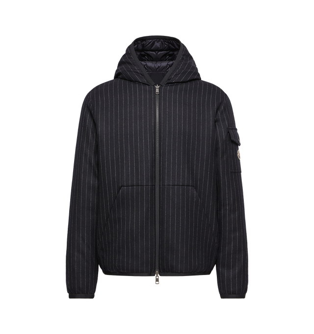 Image 1 of 1 - BLUE - Moncler Mens Ceze Down Jacket is crafted from a wool-blend fabric with a reversible quilted nylon side. Features a regular straight fit, down-filled construction, adjustable hood, front zip closure, zip pockets, snap-button chest pocket, elasticized cuffs and hem, and signature logo patch. Main Material: 99% Wool, 1% Elastane; Lining: 100% Polyamide; Fill: 90% Down, 10% Feather. Made in Romania.