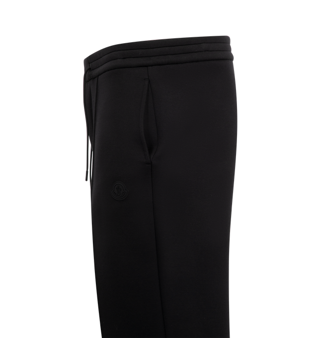Image 3 of 3 - BLACK - Moncler Logo Cotton and Neoprene Sweatpants have an elastic drawstring waistband, front pleats, side pockets, a silicone logo patch, and a snap button back pocket. 55% cotton, 45% polyester. Made in Turkey.