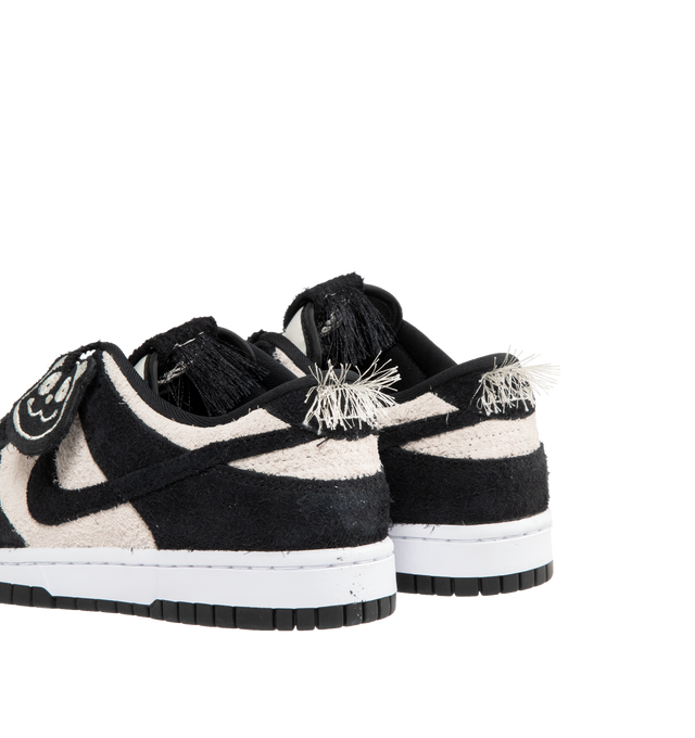 Image 3 of 5 - WHITE - NIKE Dunk Low Retro SE Sneaker featuring iconic Panda colorblocking in a hairy suede iteration, paired with plush padding, foam midsole offers lightweight, responsive cushioning, rubber outsole with classic pivot circle, low-cut collar and hairy Panda tag.