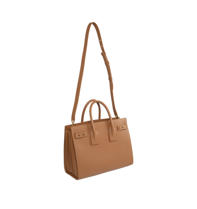Image 2 of 3 - BROWN - SAINT LAURENT Sac De Jour Small in Supple Grained Leather featuring suede lining, accordion sides, detachable padlock in leather case, interior zipped pocket, five metal feet and detachable shoulder strap. 12.5 X 10 X 6.1 inches. 95% calfskin leather, 5% metal. Made in Italy.  