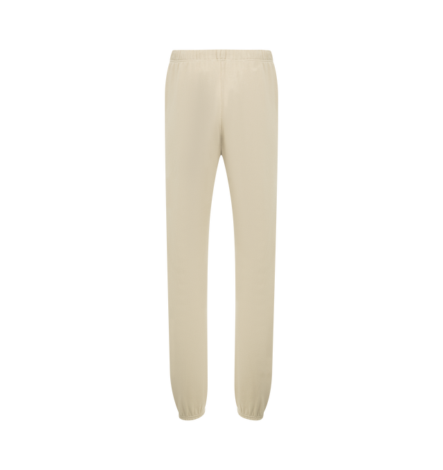 Image 2 of 3 - NEUTRAL - FEAR OF GOD ESSENTIALS Vintage Fleece Sweatpant featuring vintage fit, slimmer leg, "Essentials Fear of God" beveled metallic logo, encased elastic waistband, heavyweight drawstring with rubberized tip, side seam pockets and "Fear of God Essentials" translucent rubberized label. 80% cotton, 20% polyester fleece.
