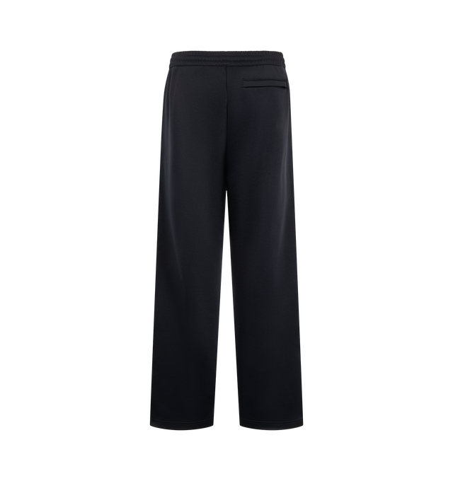Image 2 of 4 - NAVY - Carhartt WIP Men's Bolon Sweat Pant is crafted from midweight polycotton interlock and features a loose fit, adjustable elasticated waistband, embroidered graphic lettering, and zip openings at the leg hems. Designed for everyday comfort and utility, it is finished with zip welt pockets at the sides and a zip back pocket. Main Material: 64% Polyester, 36% Cotton Interlock.