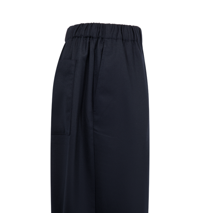 Image 3 of 3 - NAVY - JACQUEMUS Gio Pant featuring mid-high rise, tailoring wool, elastic waistband in the back, three-horn buttoned fly, pressed pleats, wide straight leg, elastic drawstring hem with stoppers and horn beads, back patch pockets and unlined. 100% virgin wool. Lining: 55% cotton, 45% polyester. Made in France.