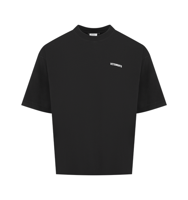 Image 1 of 2 - BLACK - VETEMENTS Iconic Logo T-shirt featuring cotton jersey, subtle fading throughout, rib-knit crewneck, logo embroidered at chest and back collar and dropped shoulders. 100% cotton. Made in Portugal.