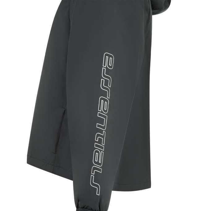 Image 3 of 3 - BLACK - FEAR OF GOD ESSENTIALS Tech Nylon Half Zip Anorak Jacket featuring tech nylon-spandex, metallic 3M-printed Essentials graphic on the sleeves, relaxed, rounded silhouette, a hood, raglan sleeves, half-zip front, elasticized cuffs and bungee toggles at the waist hem for adjustable styling and a Fear of God Essentials rubberized label stitched at the center front. 84% nylon, 16% spandex.