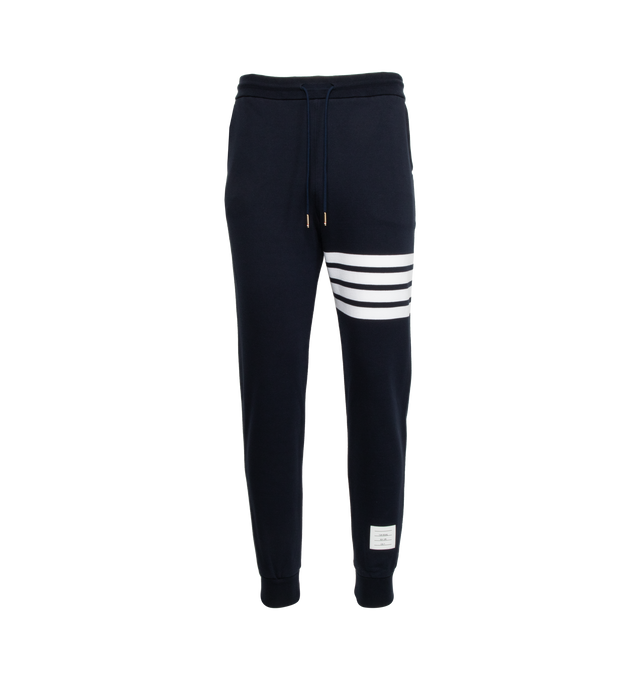 Image 1 of 5 - BLUE - THOM BROWNE cotton jersey sweatpants with pull-on waist featuring drawcords, side pockets and slim leg with signature stripes, logo patch and cuffed hems.  