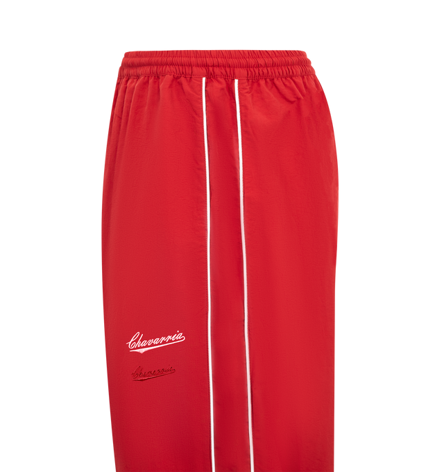 Image 3 of 3 - RED - WILLY CHAVARRIA Bad Boy Track Pants featuring elastic waistband with interior drawstring, side seam pockets, elastic hem and lightweight ripstop fabric with embroidered logo on left side. 100% nylon. Made in USA.