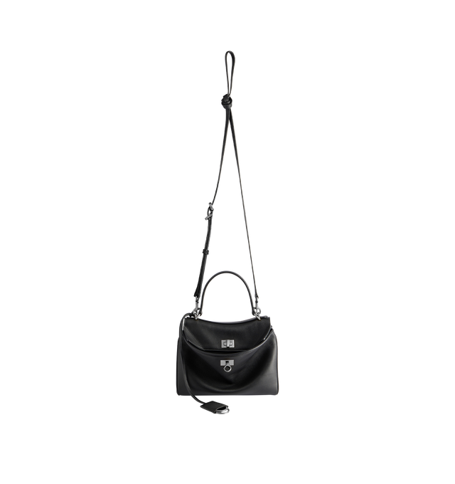 Image 4 of 5 - BLACK - BALENCIAGA Rodeo Handbag Mini featuring smooth calfskin, one handle hand carry, removable crossbody strap, removable cloche cls with two split rings, aged-silver hardware, turn lock closure, wide front pocket, 1 main compartment, 2 flat pockets at back, side snaps, 4 brass feet and nappa lambskin lining. 9" x 6.7" x 3.9". Calfskin. Made in Italy.