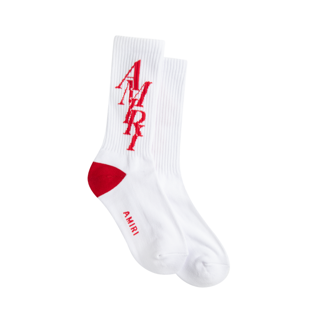 Image 1 of 2 - WHITE - AMIRI STACK SOCK are crew socks that feature an "Amiri Stack" logo motif on the calf, ribbed cuff to prevent slipping and reinforced toe and heel with a red contrasting color heel accent. 78% cotton, 20% polyester, 2% spandex. 