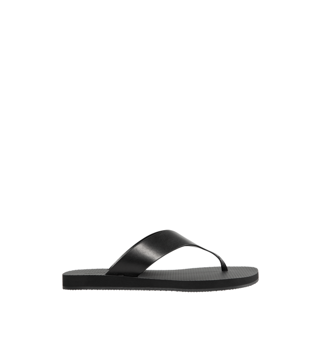 Image 1 of 4 - BLACK - THE ROW Dune Classic Ginza Sandal featuring modern flip flop sandal in sleek calfskin leather with seamless contoured strap, textured footbed, and lightly treaded rubber sole. 100% calfskin leather. Made in Italy.