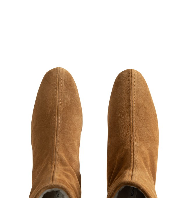 Image 4 of 4 - NEUTRAL - Toteme Women's Shearling-Lined Suede Ankle Boots are crafted from lamb suede and feature a streamlined ankle boot silhouette with a modern square toe and fold-over uppers. Designed for cold-weather wear, this refined style is enhanced by a plush shearling lining and trim, combining warmth with Toteme's signature minimalist aesthetic. Main Material: Lamb Leather Suede. Lining: Shearling. Trim: Shearling. Insole: Leather. Sole: Rubber. Includes: Shoe Box, Dust Bag. Made in Italy.
