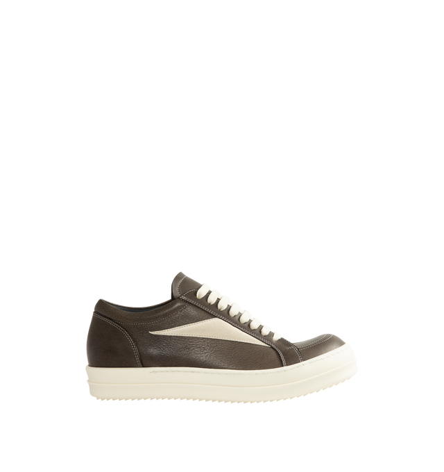 Image 1 of 5 - BLACK - Rick Owens Vintage Sneaks are designed with a low-top design including a lace-up closure, signature shark-tooth soles, and contrast stitching. Upper: 100% Cotton. Lateral Details: 100% Calf Leather. Lining: 100% Cotton. Sole: 100% Thermoplastic Rubber. Sole Height: 3.5 cm / 1.4 in. Closure: Lace-Up. Made in Italy.