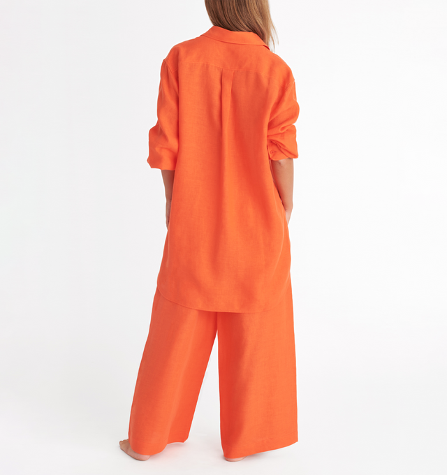 Image 4 of 4 - ORANGE - ERES Mignonette Shirt featuring long sleeves, pleated cuffs and yoke in the back with rounded slits on each side at the hem. 100% Linen. Made in Bulgaria. 