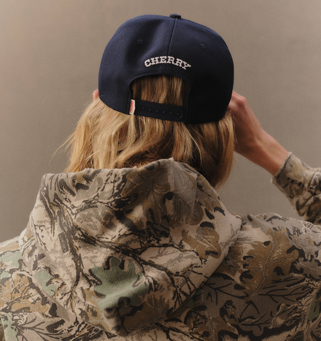 Image 6 of 6 - NAVY - Cherry LA Wool 5 Panel Hat is crafted from polyester and features a classic six-panel silhouette with embroidered detailing at the front and back. Designed with a branded flag tab at the back and an adjustable plastic snap closure, this everyday cap combines clean styling with signature Cherry LA branding.