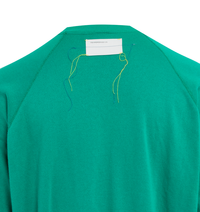 Image 4 of 4 - GREEN - This vibrant emerald green upcycled vintage sweatshirt features raglan sleeves, "1910" applique at the front, Transnomadica label at the back.  50% cotton / 50% polyester. Measurements: 26 inches in length from neckline to front hem, 26 inches from armpit-to-armpit. This collection of vintage sweatshirts, exclusively for 1910 at Hirshleifers, each featuring a hand-crafted 1910 applique at the front and Transnomadica tag at the back. Each piece features unique fit, color and design d 