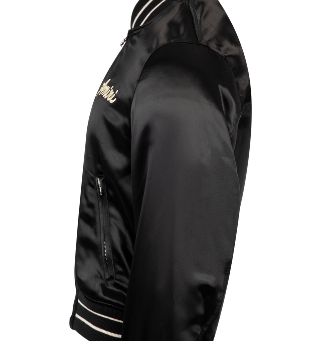 Image 3 of 3 - BLACK - AMIRI Club Amiri Bomber Satin Jacket featuring logo on chest, welt zipper pockets, double zip closure and banded rib finishes. 100% viscose. Made in Italy.